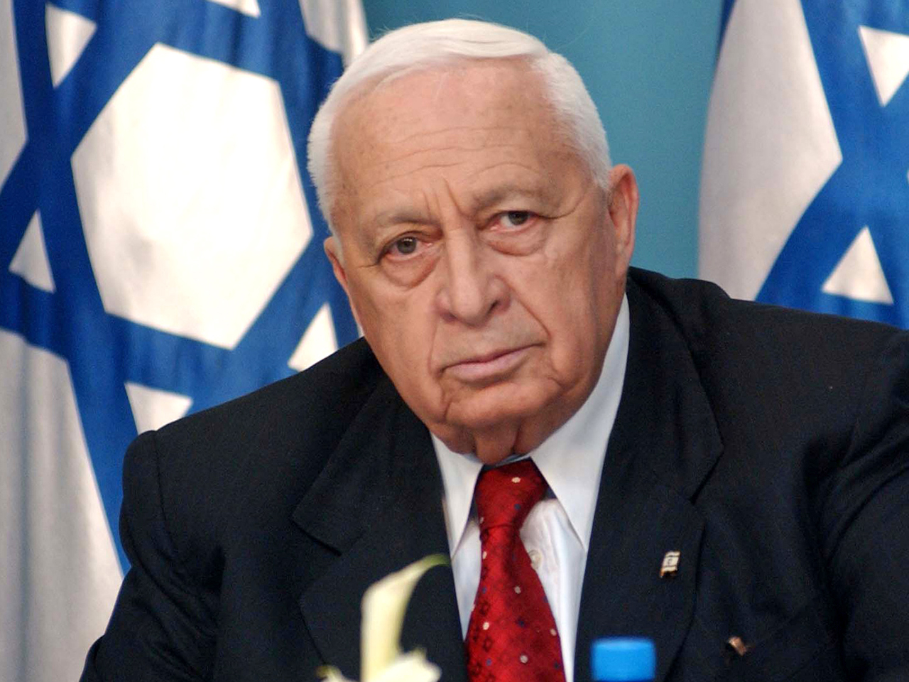Israeli Prime Minister Ariel Sharon listens to questions from the media during an impromptu news conference at his office in Jerusalem Wednesday April 21, 2004. (AP Photo/Alex Kolomoisky) ** ISRAEL OUT **