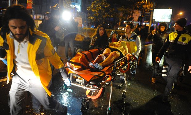 Paramedics carry an injured woman from the site of a mass shooting at an Istanbul nightclub. Photograph: Ihlas News Agency/AFP/Getty Images
