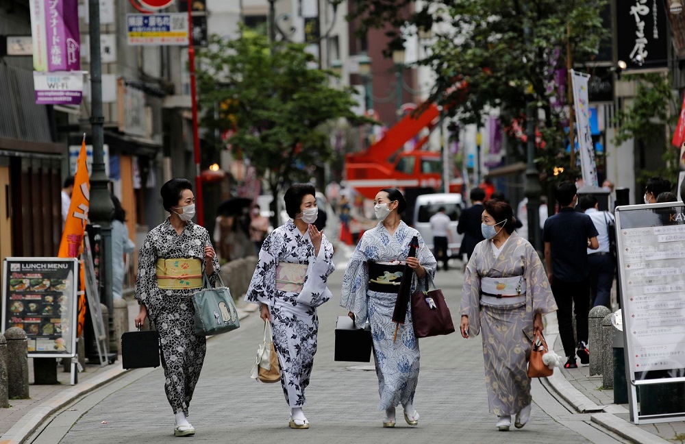 Maki, Mayu, Koiku and Ikuko, who are geisha, wear protective face masks as they walk to a restaurant after attending a dance class, during the coronavirus disease (COVID-19) outbreak, in Tokyo, Japan. July 13, 2020. Ikuko fears an extended pandemic could prompt some geisha to quit. "Now is the worst of the worst", she said. "How are we going to get through? It'll take all of our body and soul." REUTERS/Kim Kyung-Hoon     SEARCH "GEISHA COVID-19" FOR THIS STORY. SEARCH "WIDER IMAGE" FOR ALL STORIES. - RC26UH9J88EA